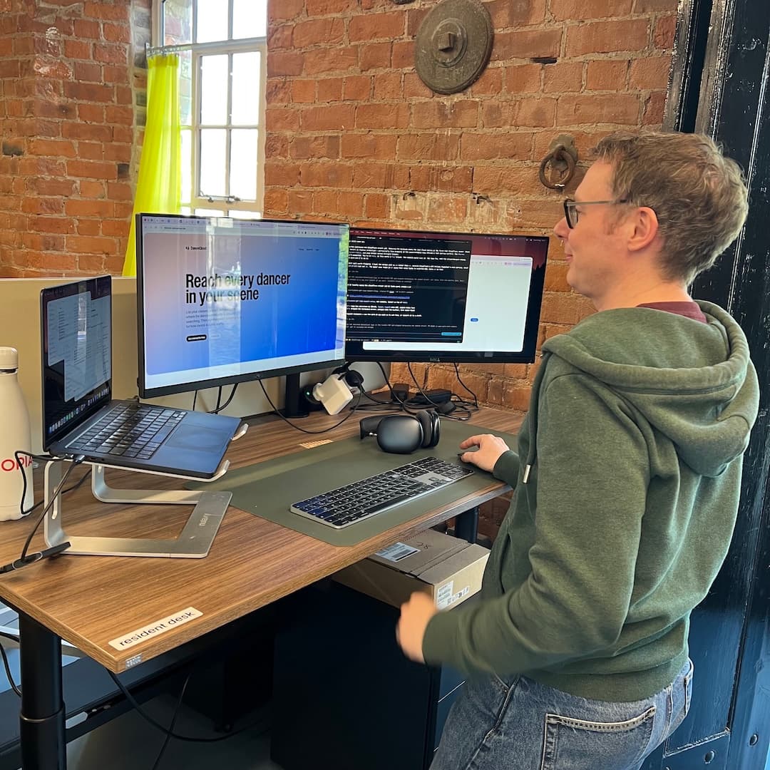 Chris at a standing desk, working on the DanceCloud site